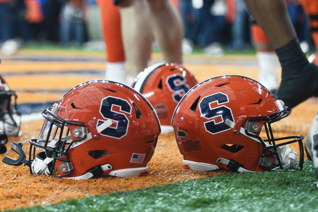 Syracuse helmets shown on the field before an NCAA college football game against Wake Forest in Syracuse, N.Y., Saturday, Nov. 25, 2023. (AP Photo/Adrian Kraus)