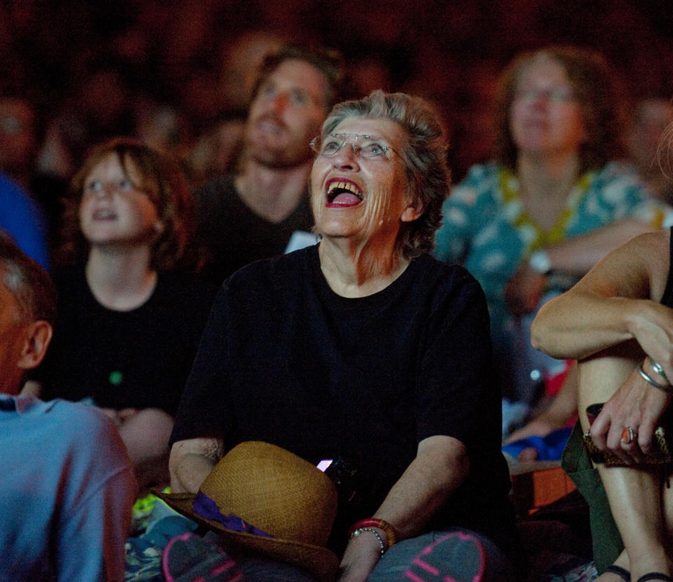 Melisande Charles of St. Paul, Minn., center, watches the Walker Art Center's first "Internet Cat Video Film Festival," showcasing the best of cat films on the Internet in Minneapolis, Thursday, Aug. 30, 2012. The Walker Art Center in Minneapolis held its first-ever online cat video festival, a compilation of silly cat clips that have become an Internet phenomenon, attracting millions of viewers for some of the videos. (AP Photo/Craig Lassig)