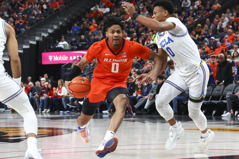 Illinois guard Terrence Shannon Jr. drives to the basket against UCLA guard Jaylen Clark during the first half of an NCAA college basketball game Friday, Nov. 18, 2022, in Las Vegas. (AP Photo/Chase Stevens)