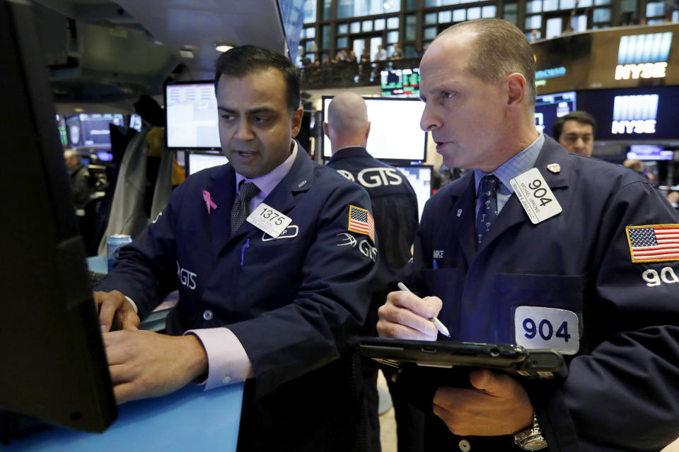 Specialist Dilip Patel, left, and trader Michael Urkonis work on the floor of the New York Stock Exchange, Friday, Oct. 26, 2018. Stocks are opening broadly lower on Wall Street, a day after a massive surge, as a number of big companies reported disappointing results. (AP Photo/Richard Drew)