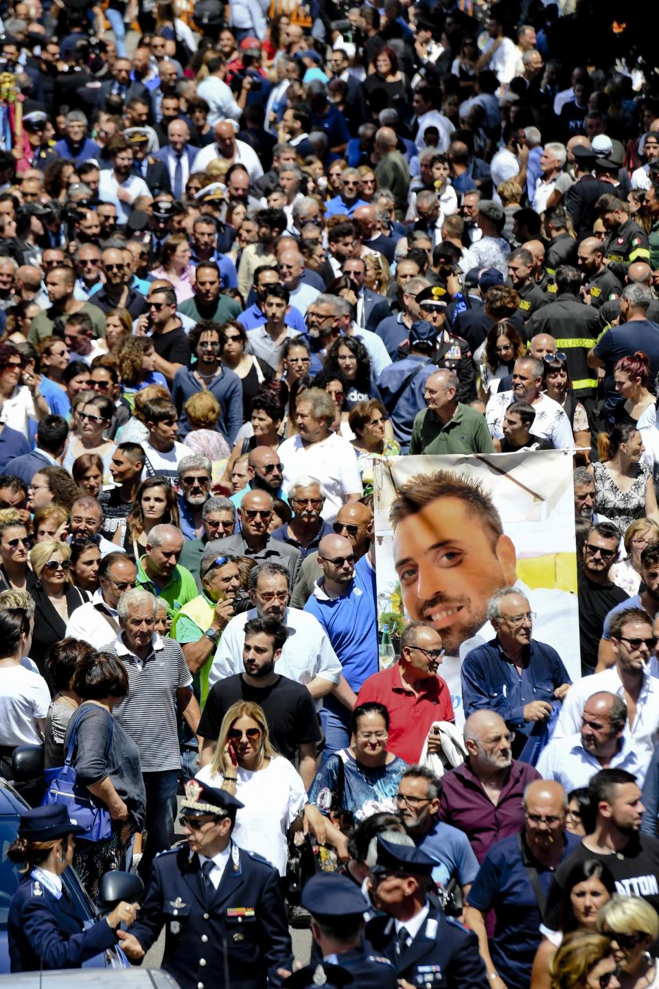 The picture of Carabinieri's officer Mario Cerciello Rega is shown during his funeral in his hometown of Somma Vesuviana, near Naples, southern Italy, Monday, July 29, 2019. Two American teenagers were jailed in Rome on Saturday as authorities investigate their alleged roles in the fatal stabbing of the Italian police officer on a street near their hotel. (Ciro Fusco/ANSA via AP)