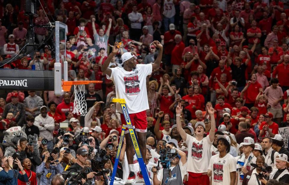 Mohamed Diarra (23) acknowledges fans as he cuts down the net following the Wolfpack’s 76-64 victory over Duke, clinching the NCAA South Regional final and securing a spot in the Final Four on Sunday, March 31, 2024 at the American Airlines Center in Dallas, Texas.