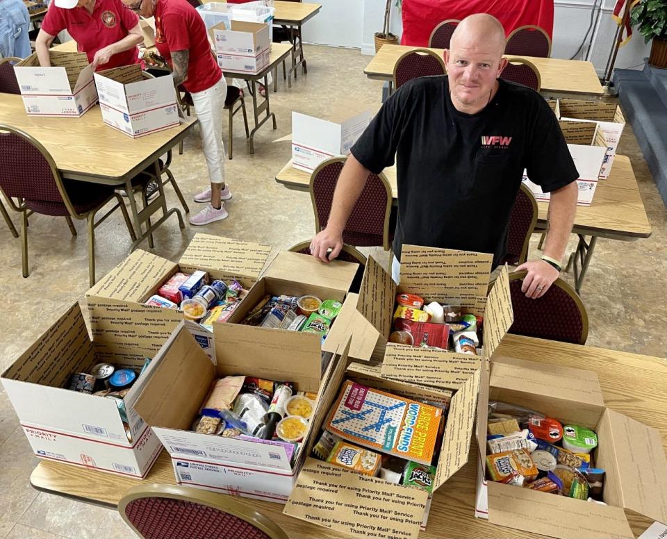 Chris Gates, a U.S. Navy veteran and commander of VFW Post 3282 in Port Orange, checks out boxes of goodies that will be sent to sailors and Marines on the USS Harry S. Truman. The carrier is deployed in the Mediterranean in support of Ukraine, said Gates.