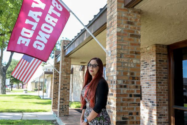 PHOTO: Taylor Michelle Massey, manager of Rushing-Estes-Knowles Mortuary, Inc. poses for a portait outside of the funeral home which features a 'Uvalde Strong' flag on Aug. 18, 2022, in Uvalde, TX. (Kat Caulderwood/ABC News)