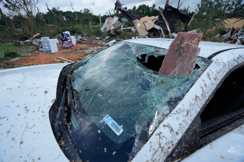 A housing beam pokes through the windshield of a Camaro following severe weather the night before that swept through Louin, Mississippi, on June 19, 2023. 