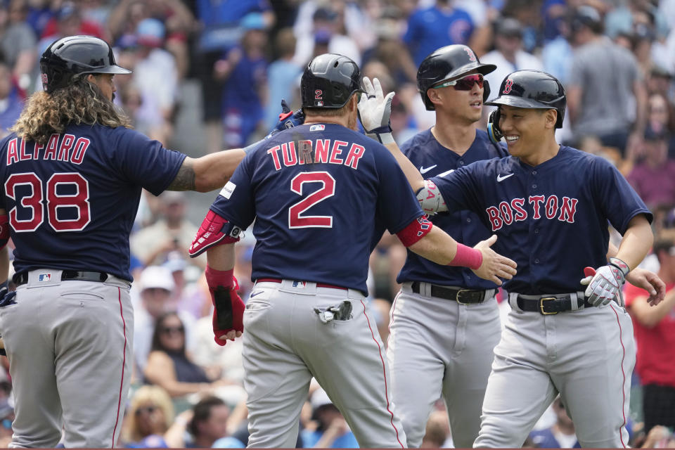 Boston Red Sox's Masataka Yoshida, right, of Japan, celebrates with Jorge Alfaro, left, Justin Turner, second from left, and Rob Refsnyder after hitting a grand slam during the fifth inning of a baseball game against the Chicago Cubs in Chicago, Sunday, July 16, 2023. (AP Photo/Nam Y. Huh)