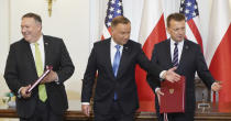 US Secretary of State Mike Pompeo, left, Poland's President Andrzej Duda, center, and Poland's Minister of Defence Mariusz Blaszczak after signing the US-Poland Enhanced Defence Cooperation Agreement in the Presidential Palace in Warsaw, Poland, Saturday Aug. 15, 2020. Pompeo is on a five day visit to central Europe. (Janek Skarzynski/Pool via AP)