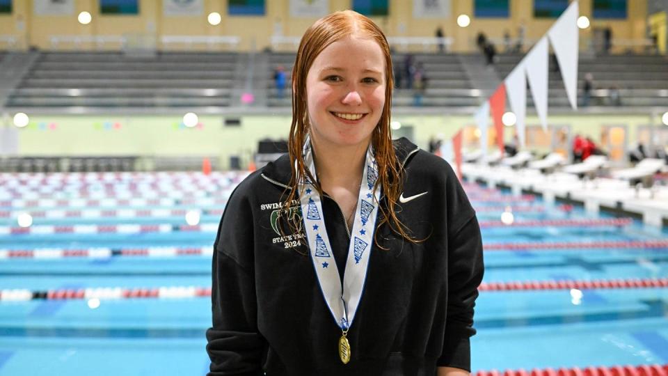Fossil Ridge girls diver Sydney Ovesen poses with her state championship medal after winning the Colorado Class 5A state diving championship on Wednesday at the Veterans Memorial Aquatics Center in Thornton.