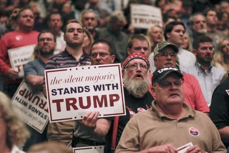 People listen as Republican U.S. presidential candidate Donald Trump addresses a campaign rally in Macon, Georgia, in this file photo taken November 30, 2015. REUTERS/Christopher Aluka Berry/Files