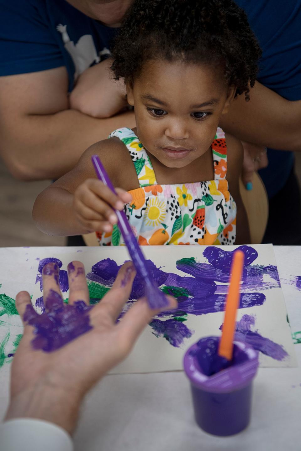 Tia’ara McSwain, 2, paints during at the Verner Center for Early Learning June 27, 2023.