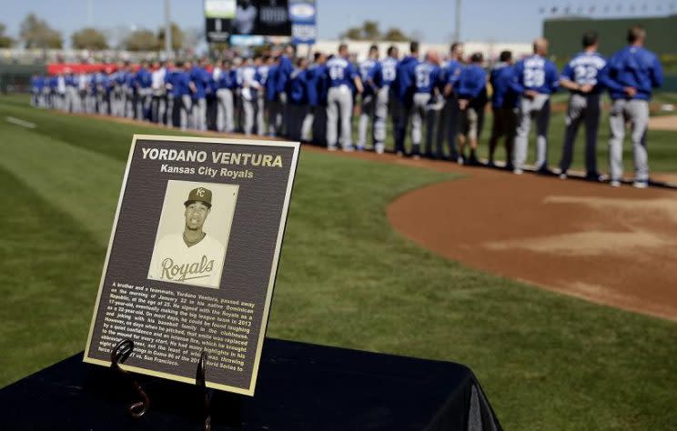 The Kansas City Royals stand for a moment a silence for Yordano Ventura before their spring opener against the Rangers. (AP)