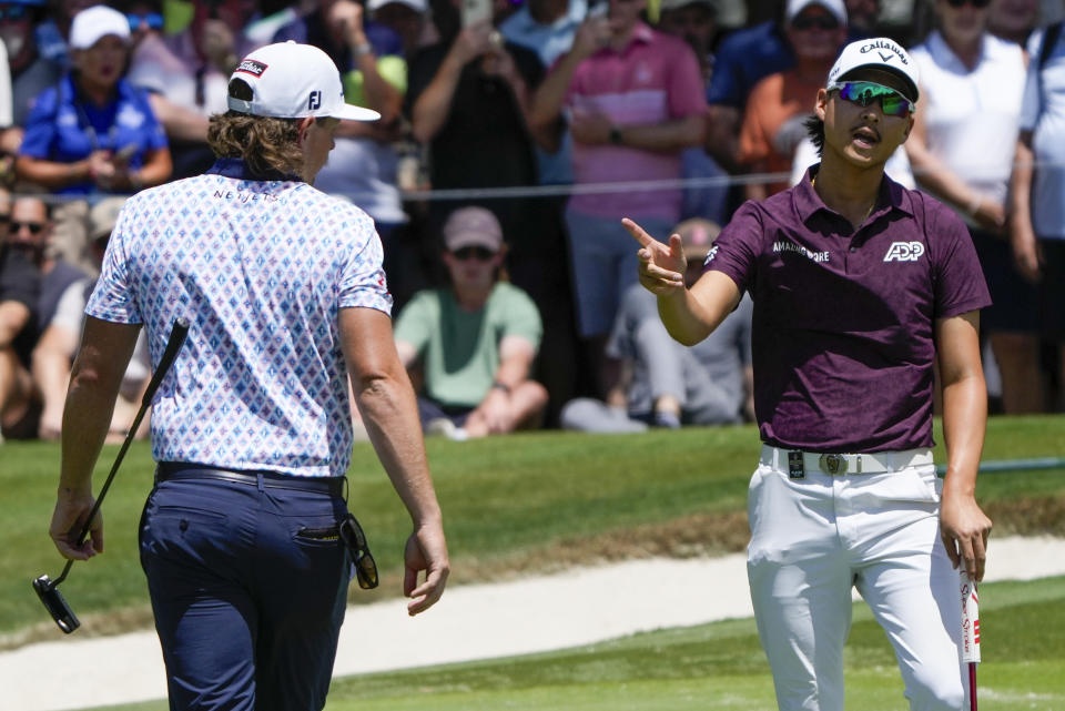 Australia's Min Woo Lee, right, reacts after a putt on the seventh green as compatriot Cam Smith watches during the second round of the Australian Open Golf Championship in Sydney, Australia, Friday, Dec. 1, 2023. (AP Photo/Mark Baker)