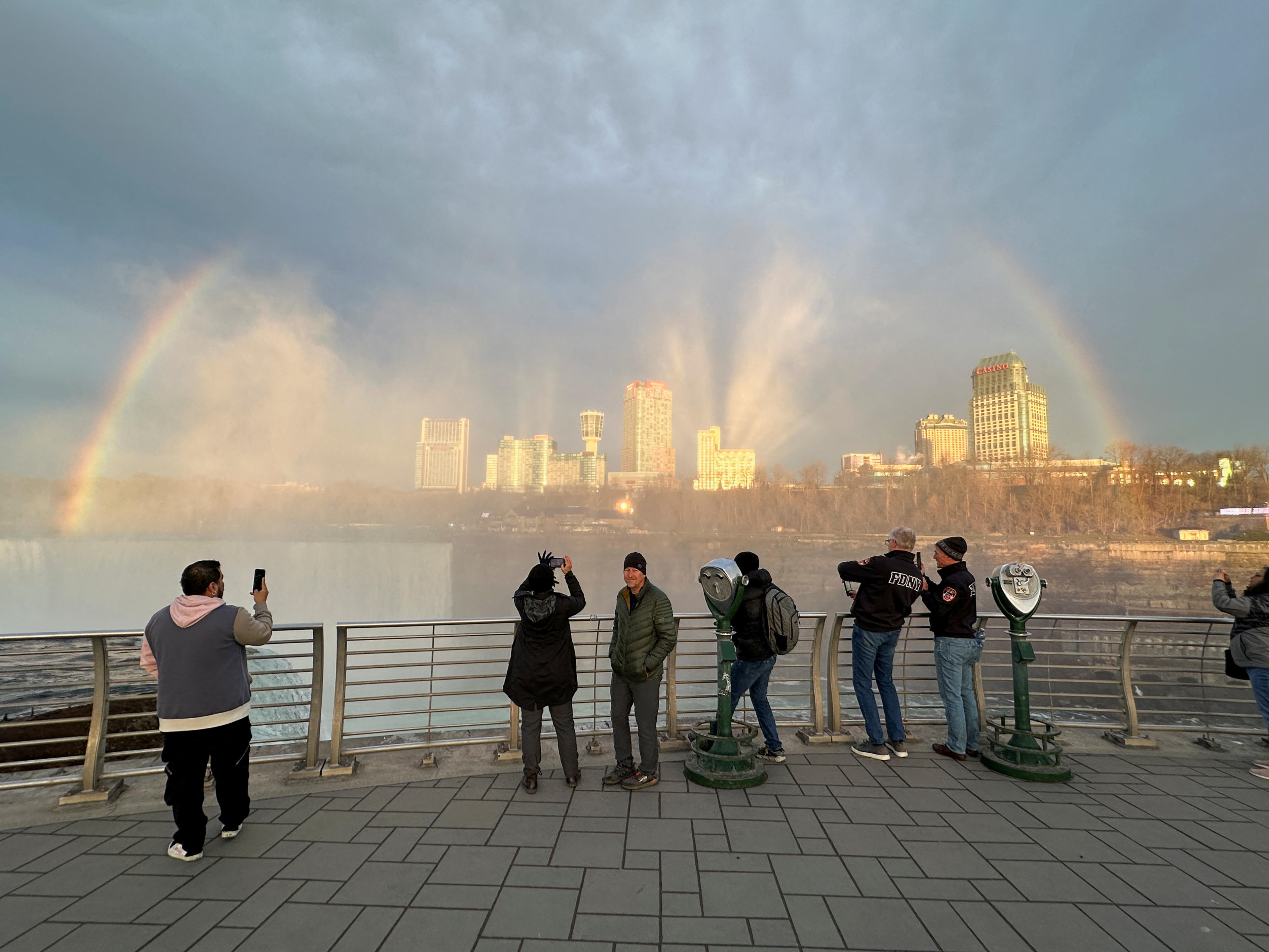 People at Niagara Falls State Park watch Niagara Falls and the rainbow ahead of a solar eclipse to take place later in the day, in New York, U.S., April 8, 2024. (Soren Larson/Reuters)