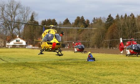 Helicopters of rescue services are seen at a field near Bad Aibling in southwestern Germany, February 9, 2016. REUTERS/Michael Dalder