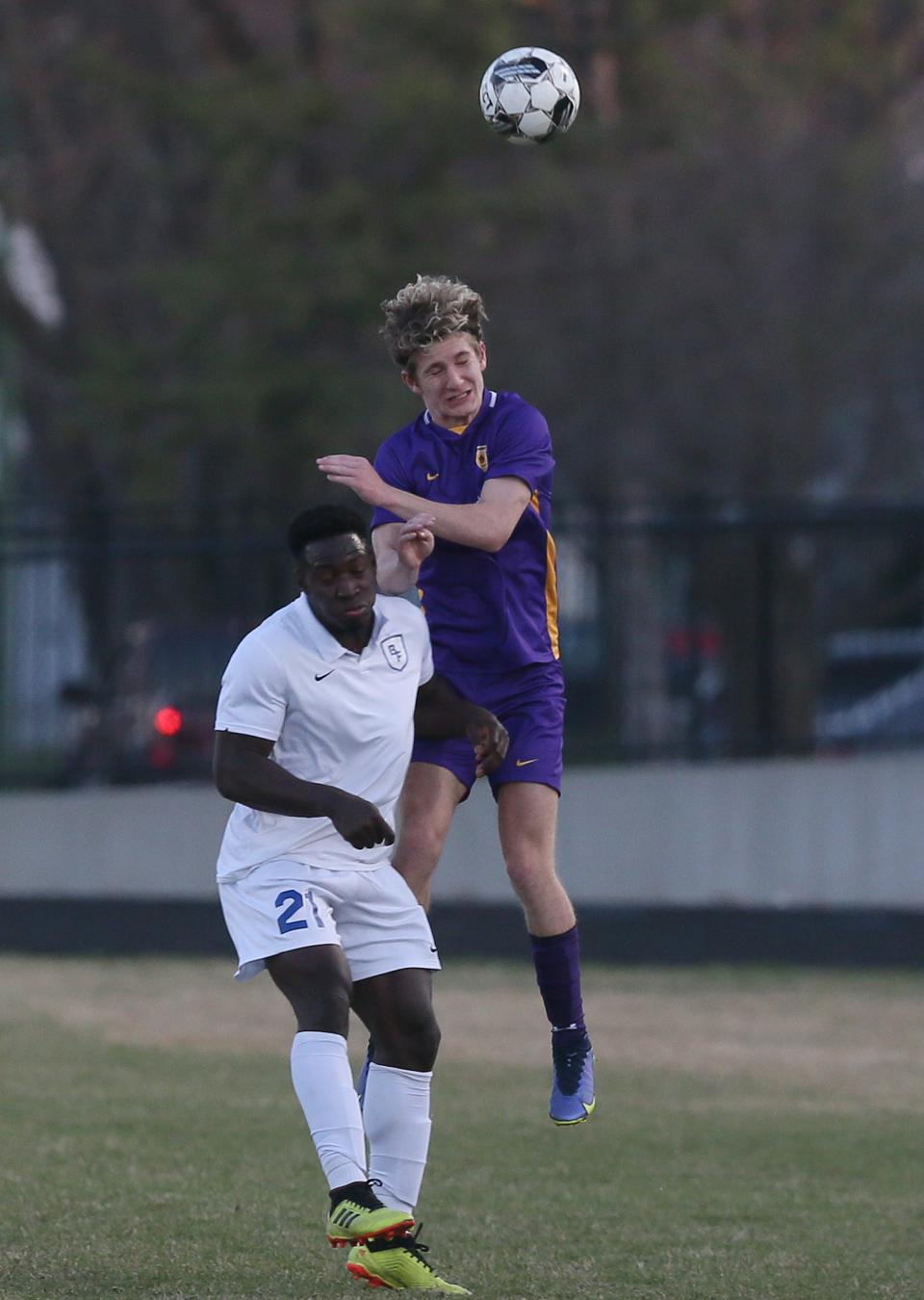 Nevada defender Jackson Reid (11) heads the ball over Bondurant Farrar forward Titus Cram (21) during the first half of the Cubs' 3-1 win over the Bluejays at Nevada High School Friday, April 7, 2023, in Nevada, Iowa.