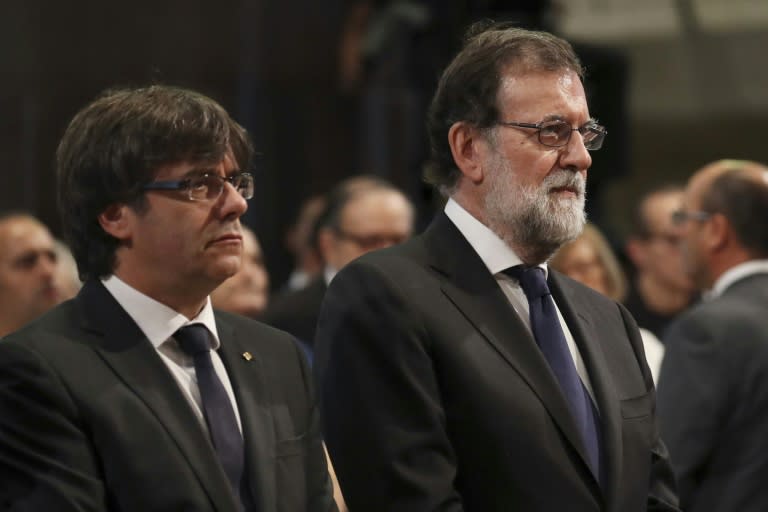 The leader of the Catalan government Carles Puigdemont (left) and Spanish Prime Minister Mariano Rajoy attend mass to commemorate victims of two attacks in Barcelona and Cambrils