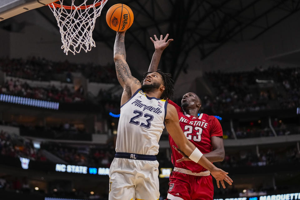 Marquette's David Joplin, left, dunks in front of North Carolina State's Mohamed Diarra during the second half of a Sweet 16 college basketball game in the NCAA Tournament in Dallas, Friday, March 29, 2024. (AP Photo/Tony Gutierrez)