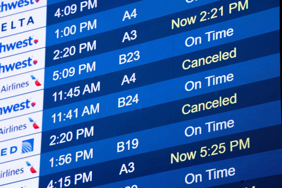 The departures board lists several cancellations at John Glenn Columbus International Airport on Thursday.