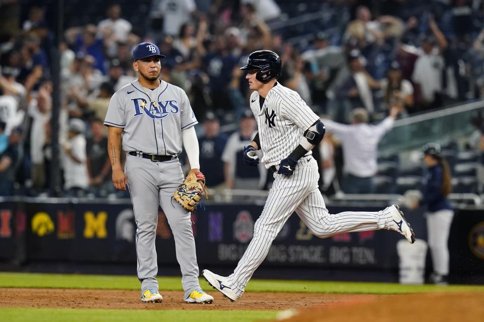 New York Yankees' Josh Donaldson passes Tampa Bay Rays' Isaac Paredes as he runs the bases after hitting a walk-off grand slam during the 10th inning of a baseball game Wednesday, Aug. 17, 2022, in New York. The Yankees won 8-7. (AP Photo/Frank Franklin II)