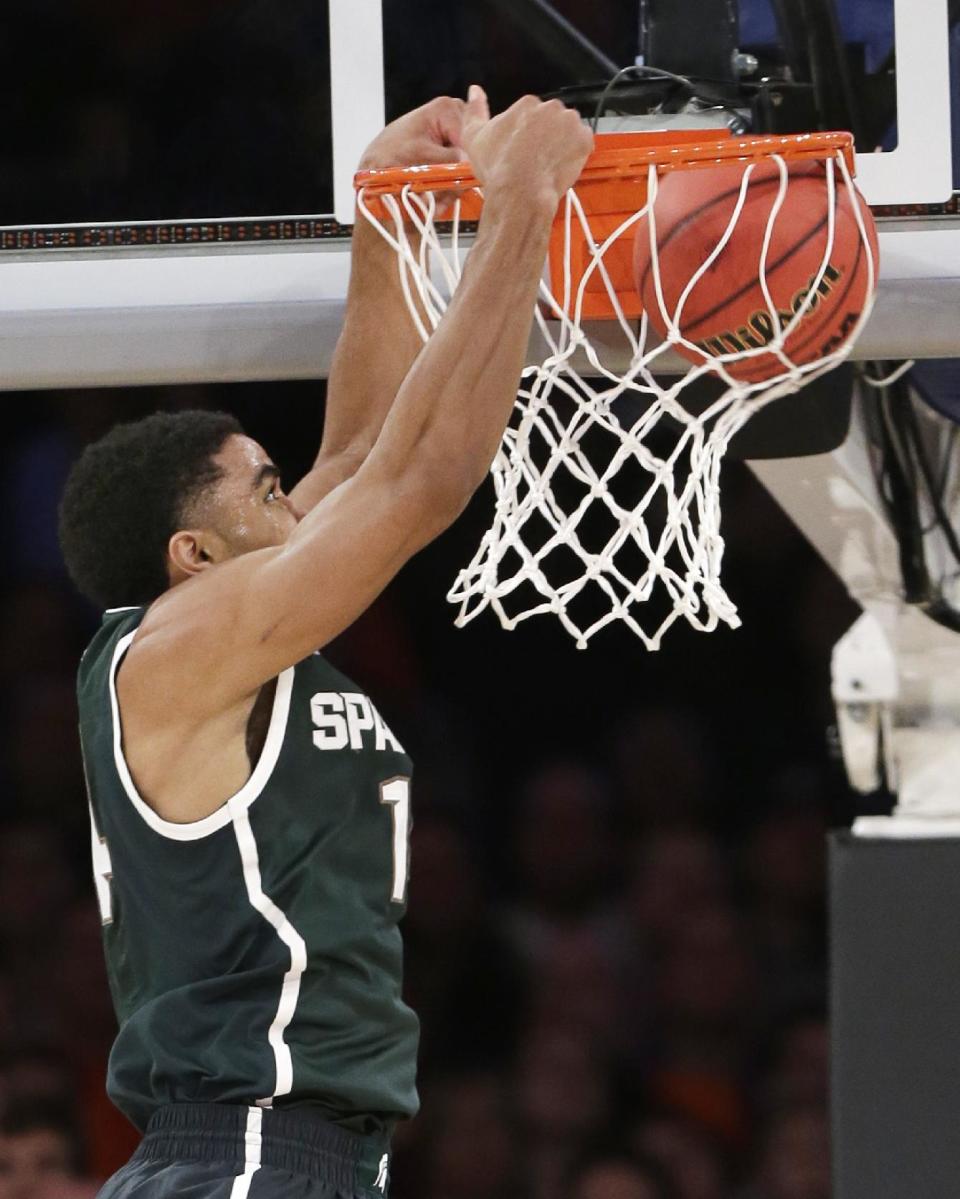 Michigan State's Gary Harris dunks during the first half of a regional semifinal against Virginia at the NCAA men's college basketball tournament, Friday, March 28, 2014, in New York. (AP Photo/Frank Franklin II)