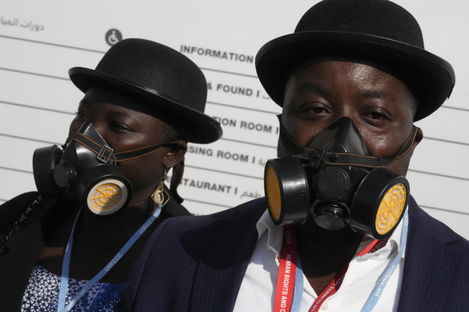 Demonstrators wear a gas masks as part of a protest with don't gas Africa at the COP27 U.N. Climate Summit, Tuesday, Nov. 15, 2022, in Sharm el-Sheikh, Egypt. (AP Photo/Peter Dejong)