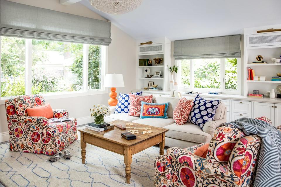 <p>Bright, patterned upholstery gives this room a bold look. Design by <a href="https://deringhall.com/interior-designers/nest-design-company" rel="nofollow noopener" target="_blank" data-ylk="slk:Nest Design Company;elm:context_link;itc:0;sec:content-canvas" class="link ">Nest Design Company</a>.</p>