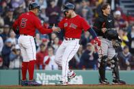 Boston Red Sox's Alex Verdugo, center, celebrates his two-run home run that also drove in Enrique Hernandez (5) as Baltimore Orioles' Adley Rutschman, right, looks away during the third inning of a baseball game, Saturday, April 1, 2023, in Boston. (AP Photo/Michael Dwyer)