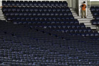 Spectators stands are empty during play in a preseason baseball game between the Yomiuri Giants and the Yakult Swallows at Tokyo Dome in Tokyo Saturday, Feb. 29, 2020. Japan's professional baseball league said Thursday it will play its 72 remaining preseason games in empty stadiums because of the threat of the spreading coronavirus.(AP Photo/Eugene Hoshiko)