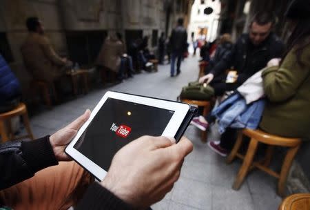 A man tries to get connected to the youtube web site with his tablet at a cafe in Istanbul March 27, 2014. REUTERS/Osman Orsal