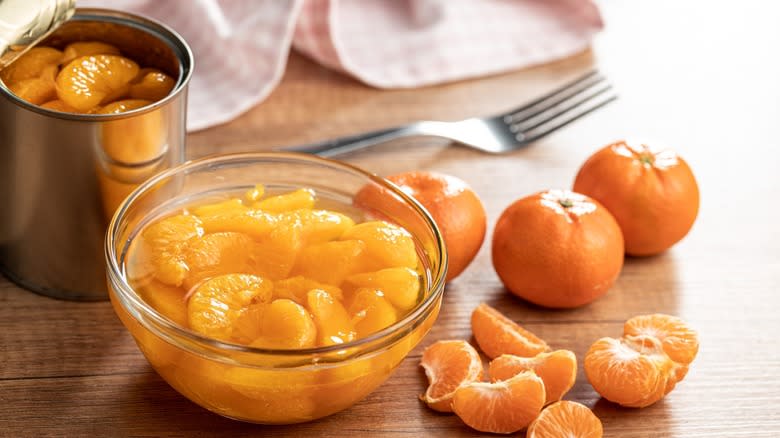 Bowl of mandarin oranges with can