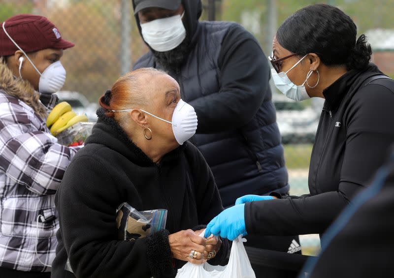 Volunteers distribute food to people in need during the coronavirus disease (COVID-19) outbreak from the Maya Angelou charter school in Washington