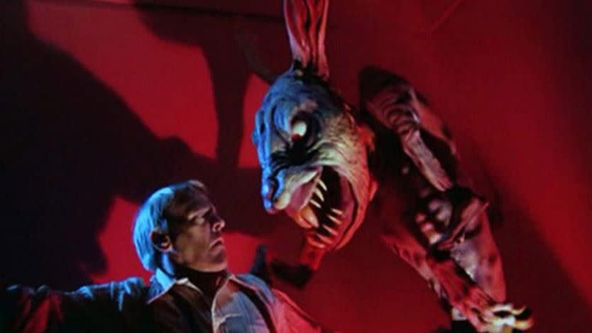 a monstrous rabbit beast with sharp teeth menaces a man in a scene from the twilight zone the movie a good housekeeping pick for best scary movies for kids