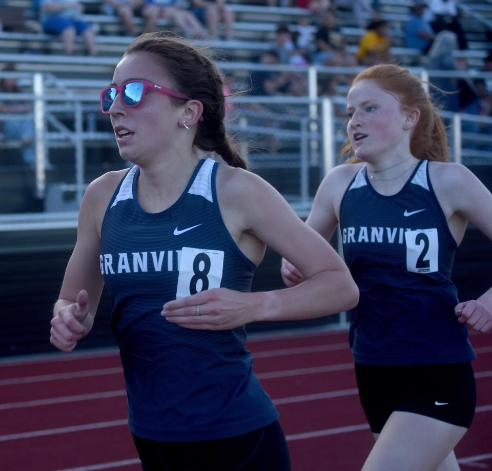 Granville's Regina Rose and Lillian Eckels compete in the Buckeye Division 1,600 during the second day of the Licking County League track meet Friday at Ascena Field. Eckels finished first and Rose second.