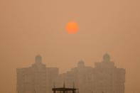 A residential building is seen shrouded in smog in Noida on the outskirts of New Delhi