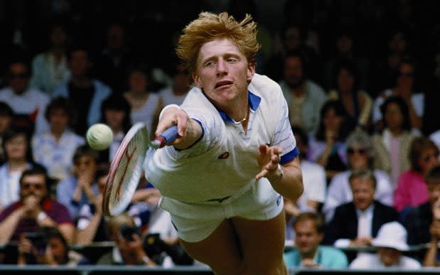 Boris Becker stretches to make a diving backhand return during the Men's singles semi final at Wimbledon in July 1985 - Credit: Bob Martin/Getty Images