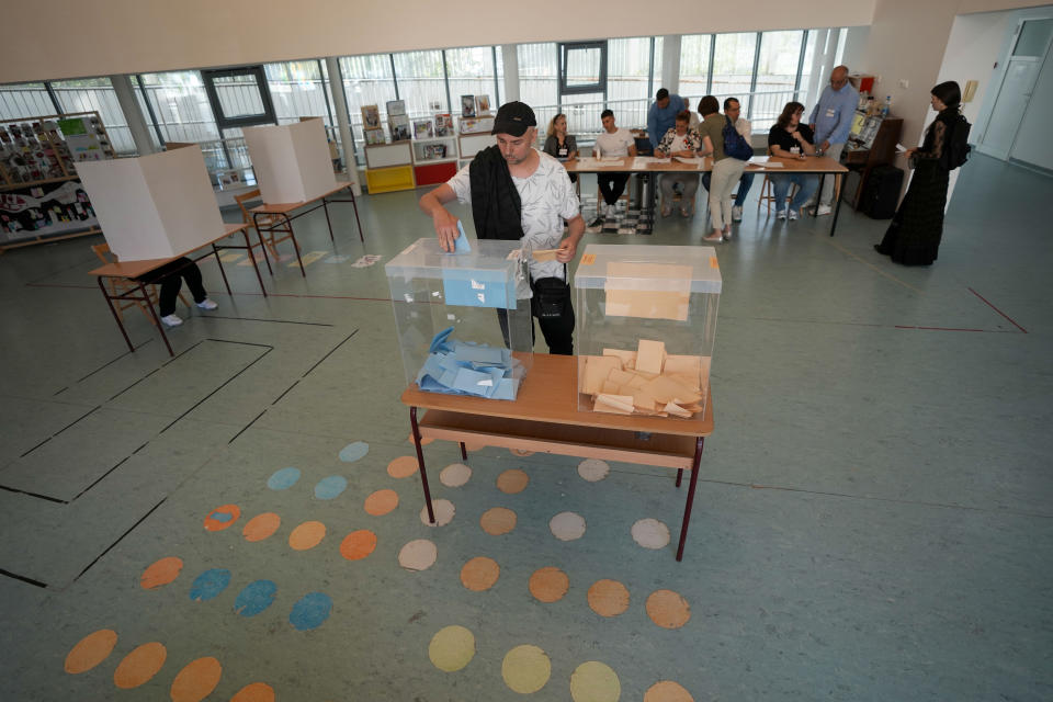 A voter casts his ballot for the local election at a polling station in Belgrade, Serbia, Sunday, June 2, 2024. Voters in Serbia on Sunday are casting ballots in a rerun election in the capital, Belgrade, and in dozens of other cities and towns, with ruling right-wing populists seeking to cement their already vast hold on power. The vote in Belgrade is being repeated after reports of widespread irregularities last December triggered political tensions and accusations that President Aleksandar Vucic's Serbian Progressive Party rigged the vote. (AP Photo/Darko Vojinovic)