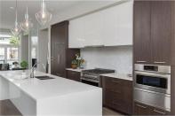 <p>The kitchen is modern and sleek. It also features a large island and stainless steel appliances. </p>