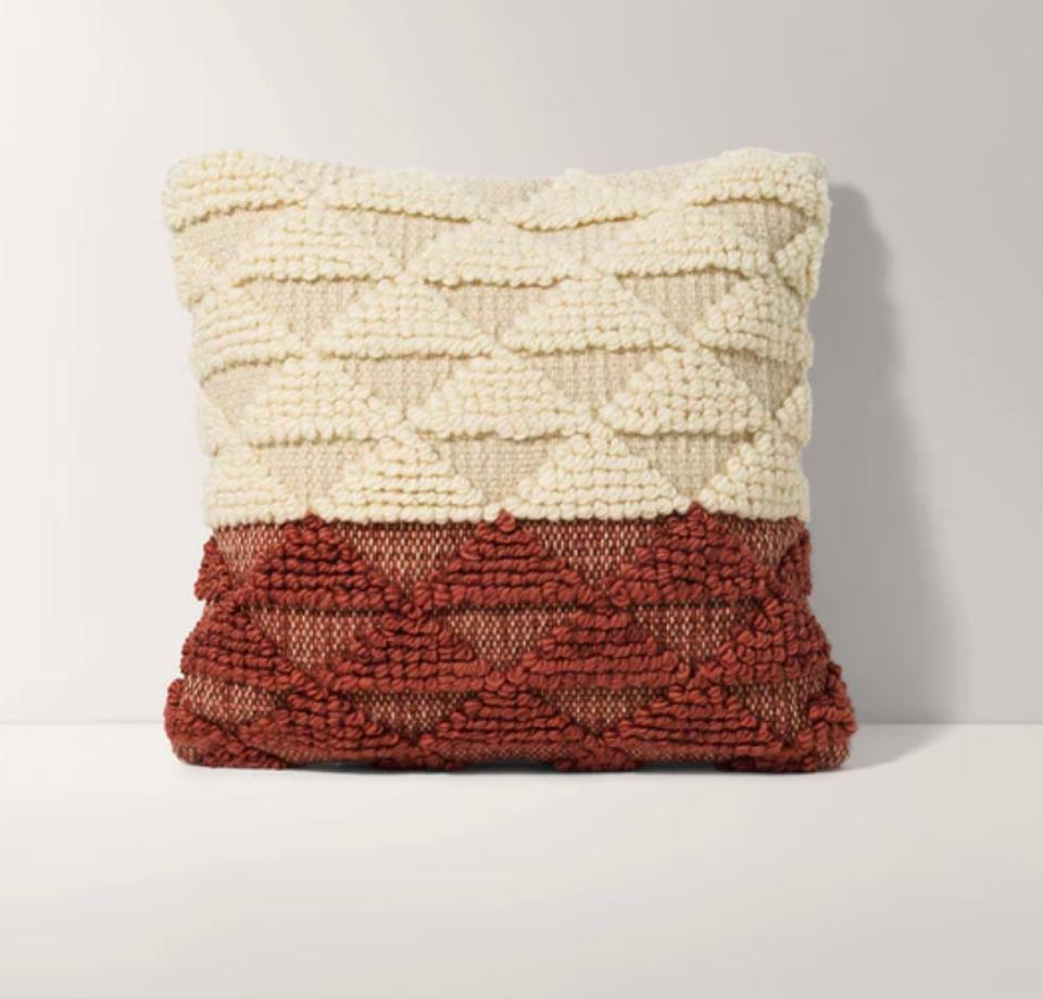 This 18 x 18 square pillow cover has a hand-woven embroidered texture with contrasting terracotta and ivory color blocks.<a href="https://fave.co/2NrsoeF" target="_blank" rel="noopener noreferrer"> Find it for $59 at Burrow</a>.