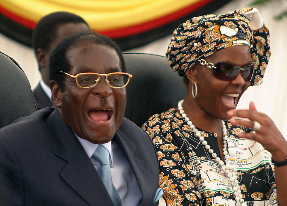 <p>Mugabe and his wife, Grace, react during a visit to a hospital in Harare in 2008. (Photo: AP) </p>