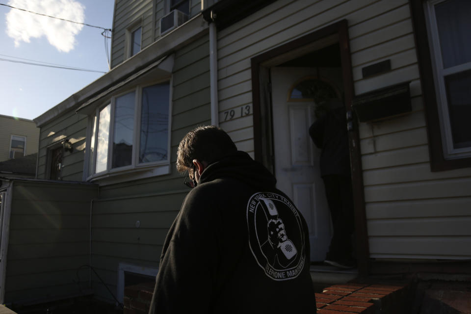 Brian Walter wears a New York City Transit sweatshirt while walking with his son James in the Queens borough of New York, Wednesday, April 7, 2021. Walter, deemed an essential worker during the pandemic as a transit employee, did most of the grocery shopping and errand running for his family and worries that he may have infected his father. John Walter died of COVID-19 on May 10, 2020. (AP Photo/Jessie Wardarski)