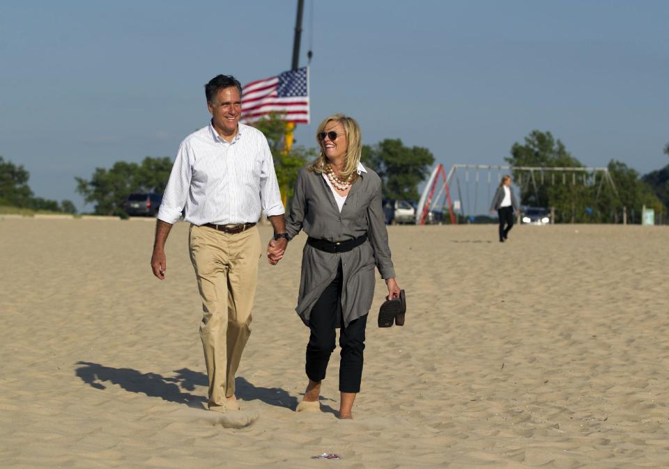 Republican presidential candidate, former Massachusetts Gov. Mitt Romney, left, takes a walk with his wife Ann, on the beach after a campaign stop at Holland State Park on Tuesday, June 19, 2012 in Holland, Mich. (AP Photo/Evan Vucci)