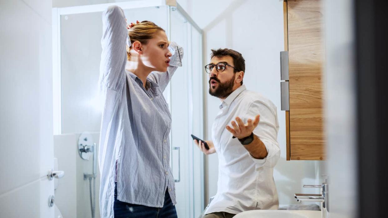 man and woman couple arguing in the bathroom