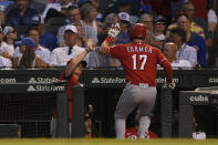 Cincinnati Reds' Kyle Farmer (17) celebrates with manager David Bell, left, at the dugout after hitting a solo home run during the fourth inning of a baseball game against the Chicago Cubs, Monday, July 26, 2021, in Chicago. (AP Photo/Paul Beaty)