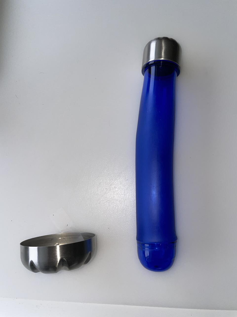 A blue tube with a metallic cap next to a separate silver-colored round lid, against a white background