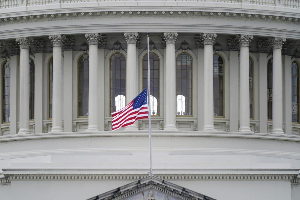 FILE - In this Jan. 8, 2021 file photo, an American flag flies at half-staff in remembrance of U.S. Capitol Police Officer Brian Sicknick above the Capitol Building in Washington. (AP Photo/Patrick Semansky)