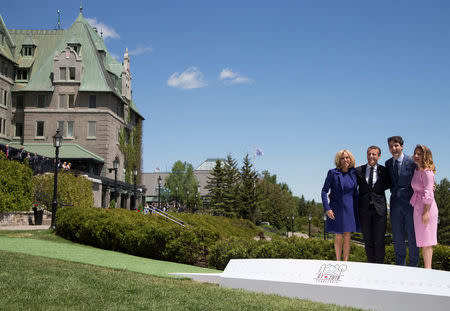 France's President Emmanuel Macron (2nd L) and his wife Brigitte (L) pose with Canada's Prime Minister Justin Trudeau and his wife Sophie Gregoire Trudeau during the official welcoming ceremony the G7 Summit in the Charlevoix town of La Malbaie, Quebec, Canada, June 8, 2018. REUTERS/Christinne Muschi