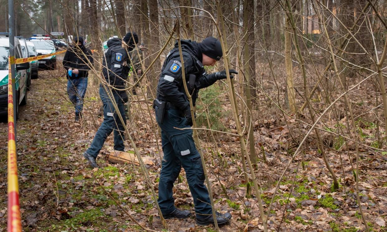 <span>Police officers search near the home of Leonid Volkov after the brutal attack on him last week.</span><span>Photograph: Mindaugas Kulbis/AP</span>