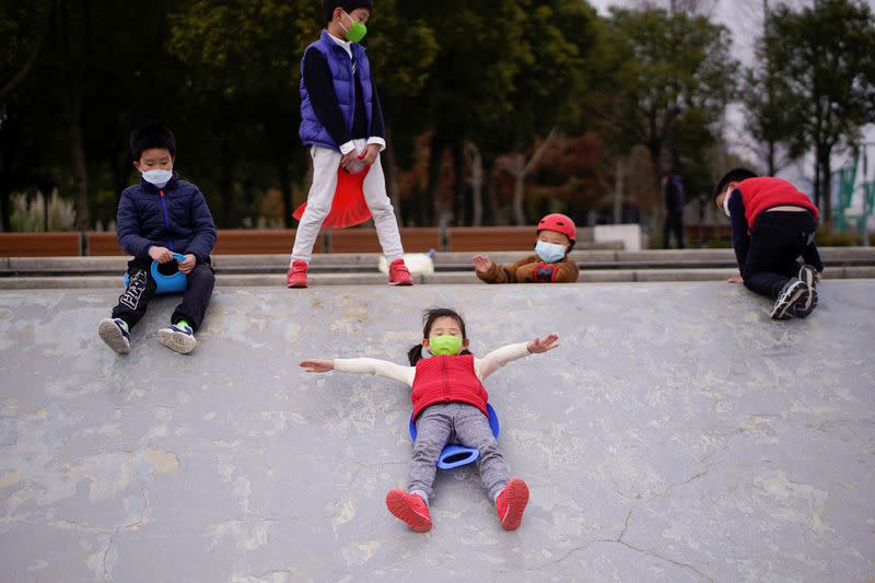 Children wearing face masks play at a park, as the country is hit by an outbreak of the novel coronavirus, in Shanghai