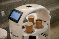 A robot that takes orders, makes coffee and brings the drinks straight to customers is seen in a cafe in Daejeon