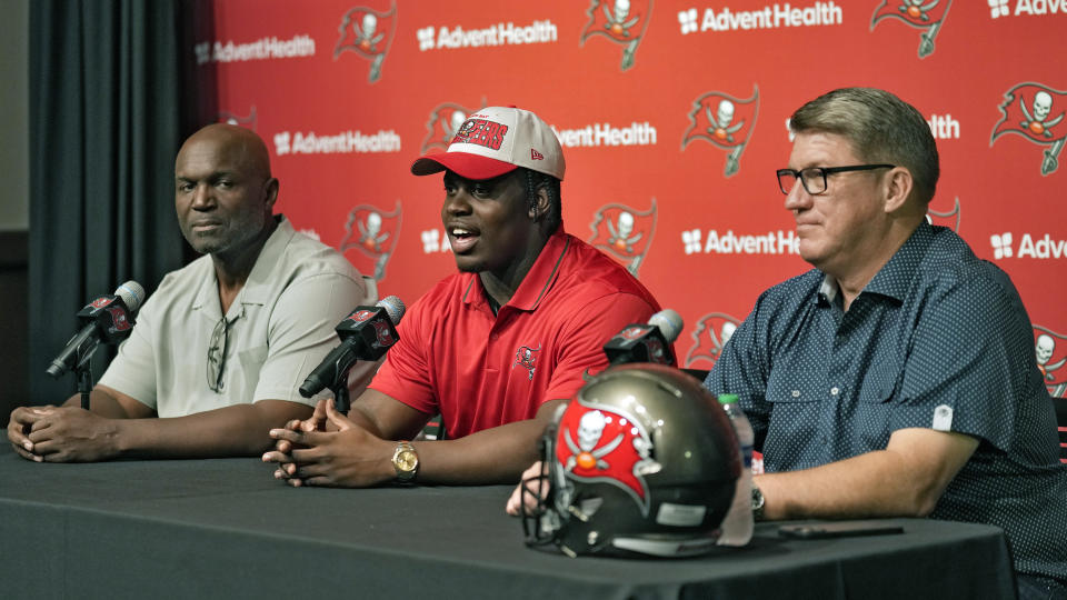 Tampa Bay Buccaneers 2023 first round draft pick Calijah Kancey, center, answers a question as he sits with head coach Todd Bowles, left, and general manager Jason Licht during a news conference Friday, April 28, 2023, in Tampa, Fla. Kancey played his college football at Pittsburgh. (AP Photo/Chris O'Meara)